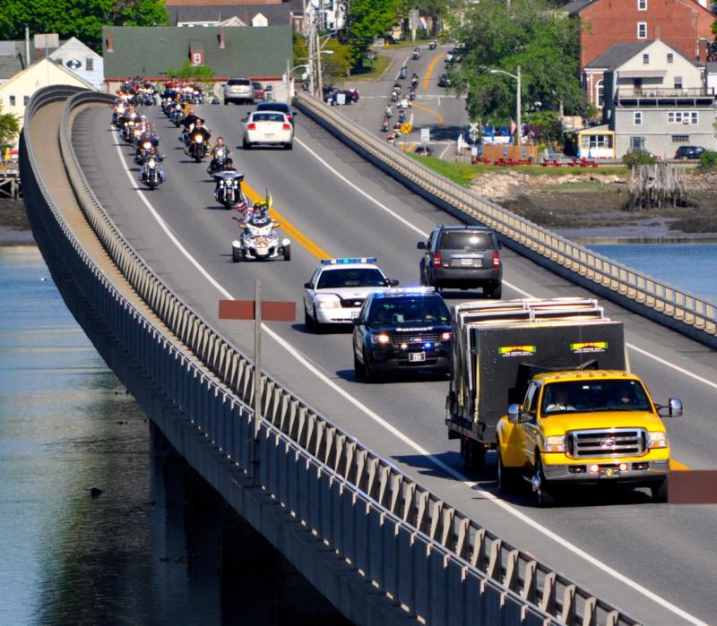 The Moving Wall, seen here being towed by the yellow truck, and motorcyclists cross the bridge from Wiscasset to Edgecomb. Courtesy of Kim Traina
