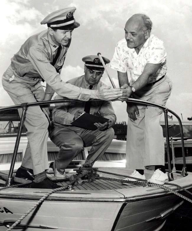 The uniforms may have changed but the USCG Auxiliary still checks the bow light as part of a free Vessel Safety Check or VSC for recreational boaters. The VSC process includes every item that will be checked if boarded by the Coast Guard, no fines will be levied or reports filed; the inspection results are confidential and serve only to give the boater a list of any items that may need repair or replacement. Courtesy of USCG Auxiliary archives