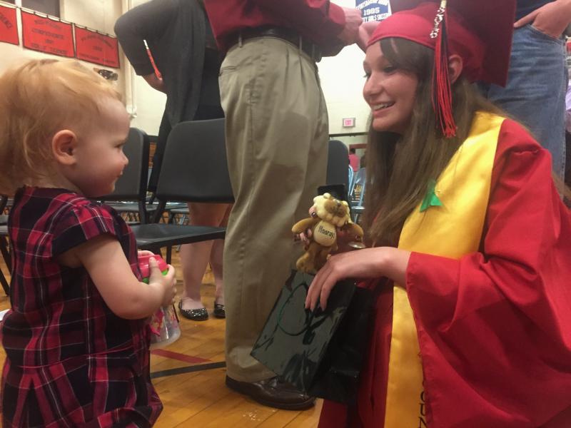 Class of 2016 member Alisyn Richardson, right, meets with cousin Cecily LeRoy, 16 1/2 months, after commencement. SUSAN JOHNS/Wiscasset Newspaper
