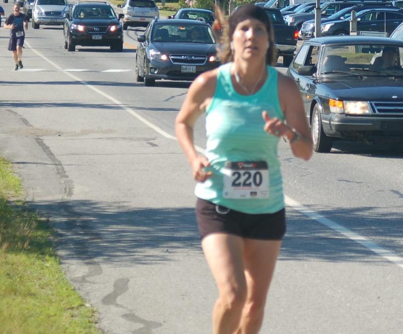 Kirsten Gray of Boothbay Harbor crosses the line third in the 5k race on July 2. ART MAYERS/Boothbay Register