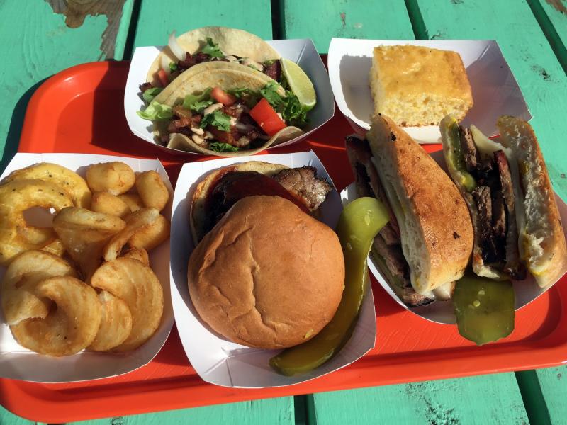 A tray full of some of the Twisted Iron Grille’s specialties: Barbecue beef brisket sandwich, a Cubano sandwich, pork belly tacos, twisted fries and fried cheese curds. SUZI THAYER/Boothbay Register
