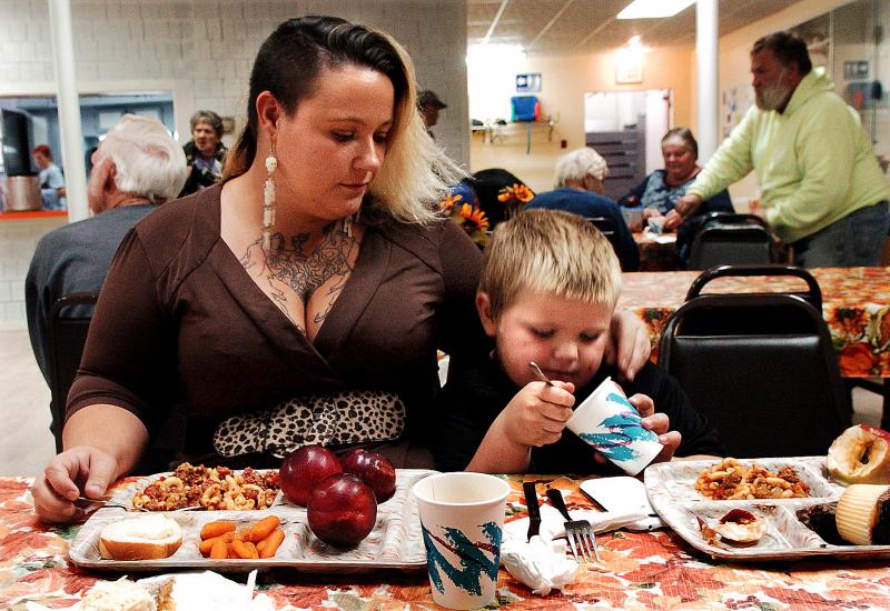 Single mother Adena Wilcox and her son, Michael, eat dinner at St. Anthony’s Soup Kitchen in Skowhegan. (Photo courtesy Dave Leaming)