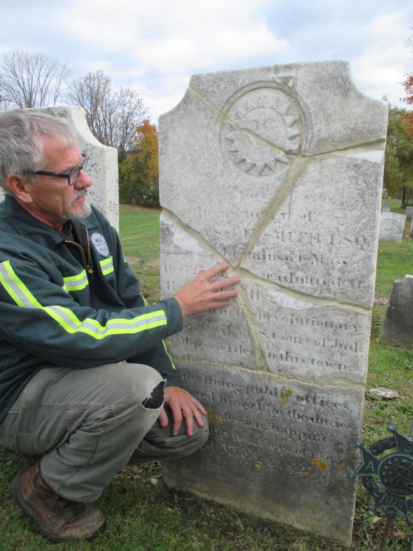 Steve Christiansen, a member of Wiscasset Public Works Department, looks at the restored gravestone marking the final resting place of Manasseh Smith, who served as a chaplain in the Continental Army during the American Revolution. PHIL DI VECE/Wiscasset Newspaper