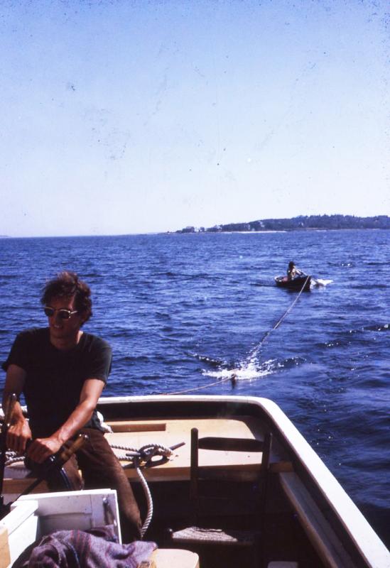 Deckhand Bill Coyne at the helm, me being towed in the dinghy. Photo owned by Suzi Thayer
