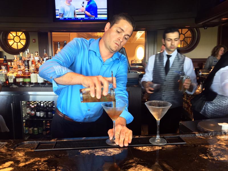 Rob Carlin mixes up a couple manhattans at the country club. SUZI THAYER/Boothbay Register