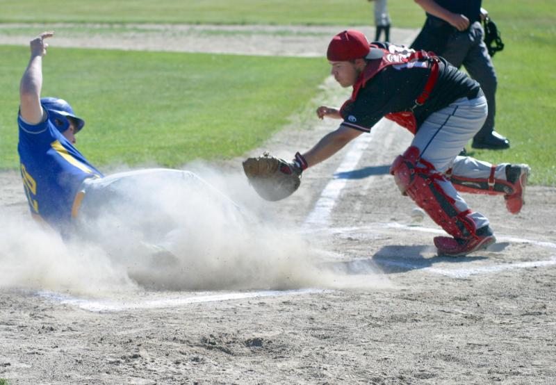 Boothbay’s Cameron Crocker slides under the tag of Wolverine catcher Andrew Hendrickson after hitting an inside the park home run in the first inning. PHIL DI VECE/Wiscasset Newspaper