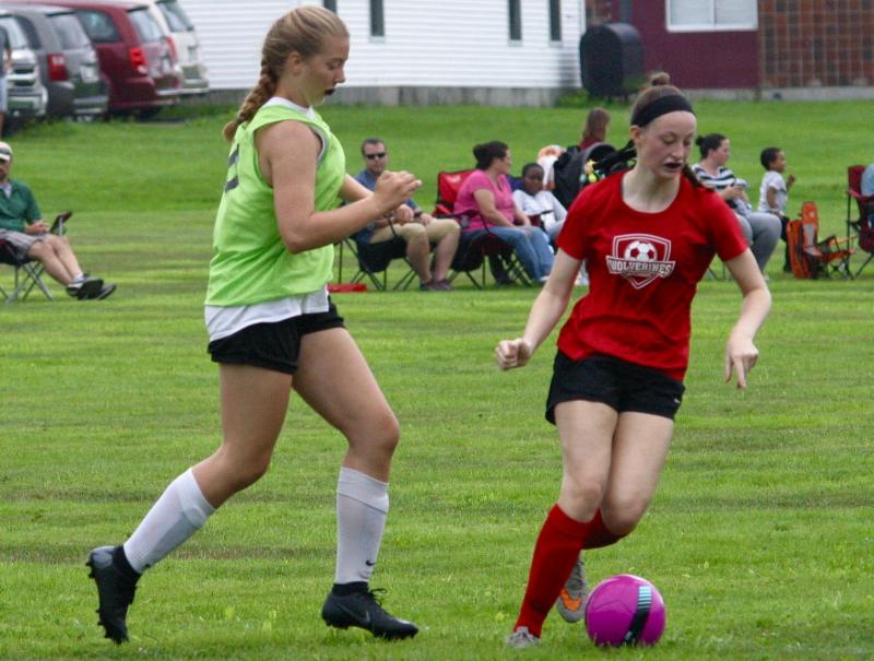 Gwen Webber, right, shown here playing in the game with Lincoln Academy, scored the Wolverines' only goal in the round robin tournament. PHIL DI VECE/Wiscasset Newspaper