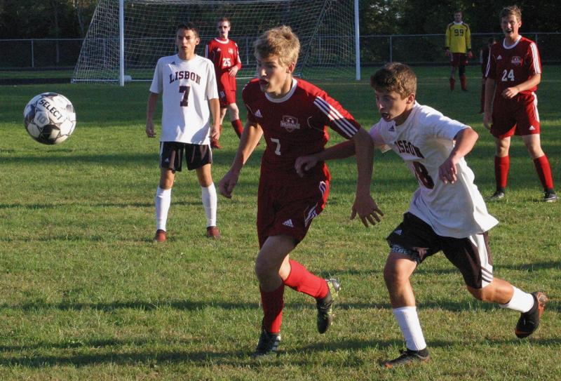 Wolverine Matt Chapman and Lisbon’s Hunter Brissette pursue a loose ball. Chapman netted the game-winning goal for Wiscasset/Boothbay. PHIL DI VECE/Wiscasset Newspaper
