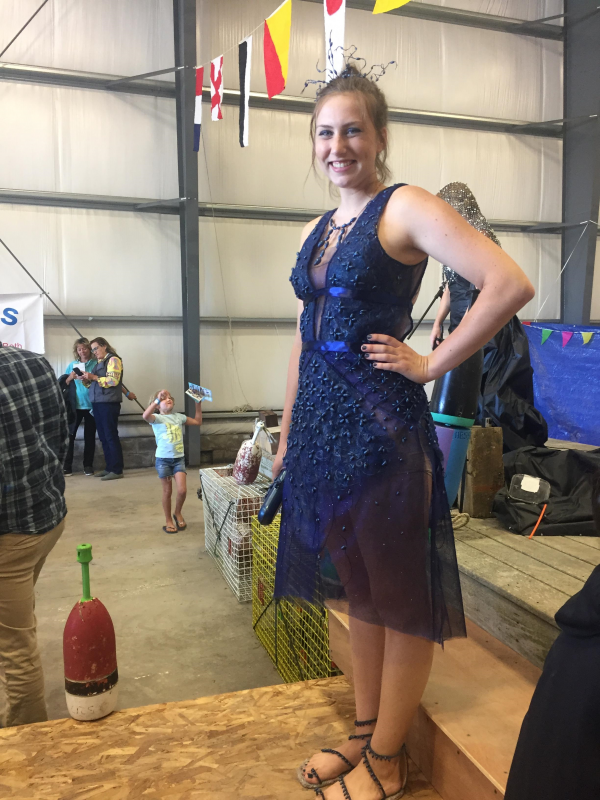 Page Brown wearing Tobi Nevers who won in the Best Materials category. An intricate mosaic of hand-painted and dyed netting, rope and seaweed pods used as beading. Homemade shoes use cork and cording. This is accompanied by an evening clutch adorned with rope and seaweed pod beading. LISA KRISTOFF/Boothbay Register