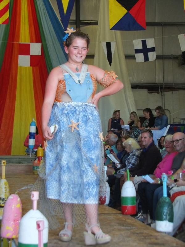 Student designers of Team Della’s creation modeled by Della Hahn, dazzling in a vintage canvas sailing harness. Her sail cloth skirt is covered with netting and starfish and is painted with blue marine paint. LISA KRISTOFF/Boothbay Register