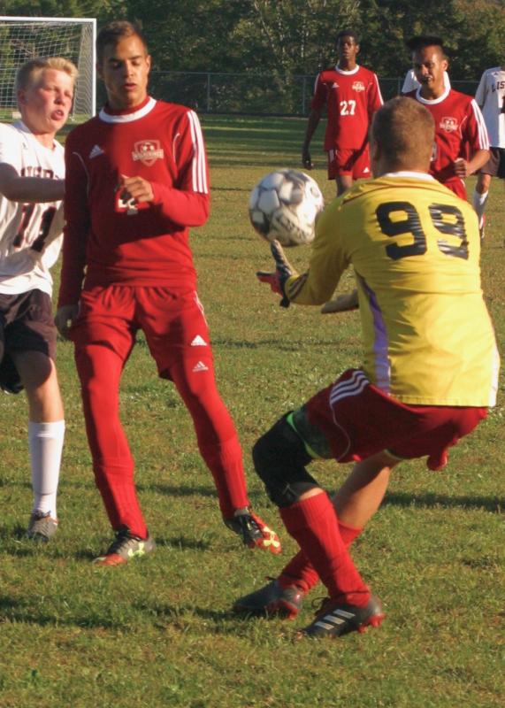 Caleb Gabriele makes a save early in the first half. That’s his brother Josh in the background. Also pictured is Lisbon’s Justin Viollette. PHIL DI VECE/Wiscasset Newspaper