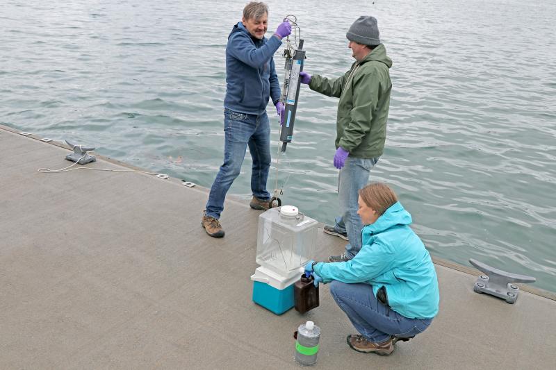 Bigelow Laboratory scientists Ramunas Stepanauskas and Laura Lubelczyk work with University of New Hampshire scientist Kai Ziervogel to collect water for analysis from the Bigelow Laboratory dock. A new $6 million project will connect the genetic makeup of individual microbes to their environmental roles and build economic capacity in Maine, New Hampshire and Nevada. Courtesy of Bigelow Laboratory for Ocean Sciences