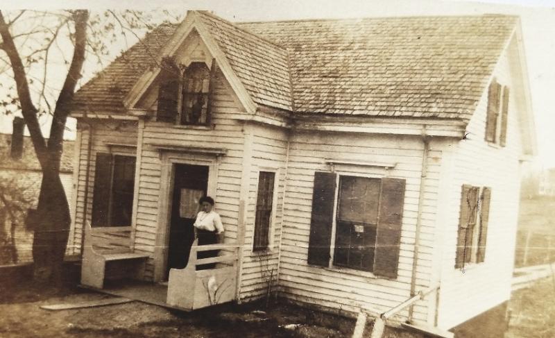 Edna Jones, previous owner, stands on the porch of her family’s Wiscasset home years ago. Was she turning the lights off? Courtesy of Pam Logan