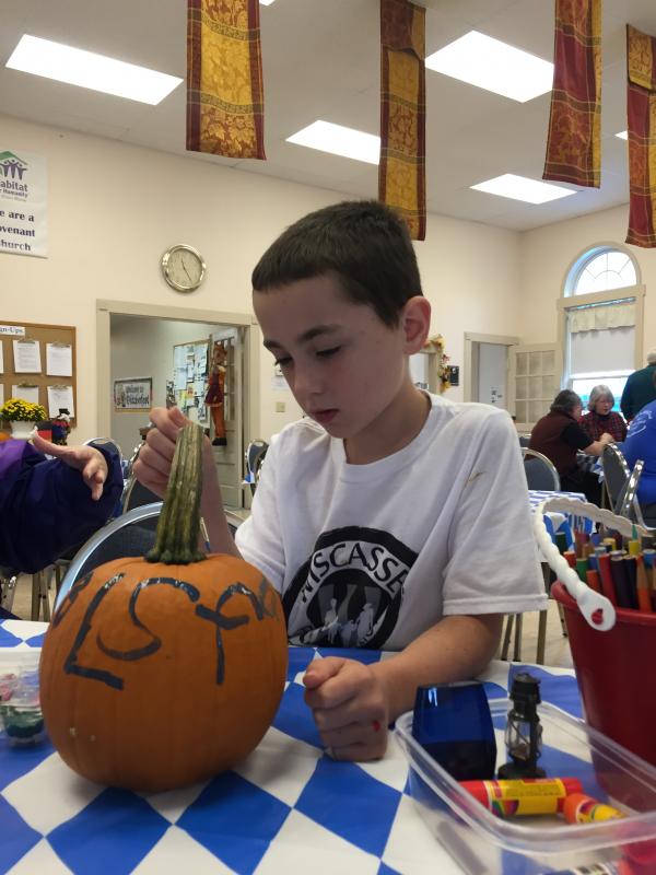 Brandon Seigars, 8, of Alna paints a pumpkin at Oktoberfest. SUSAN JOHNS/Wiscasset Newspaper