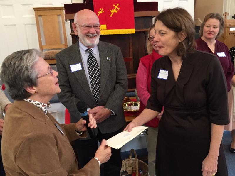Summerfest co-Chair Nancy Roby hands a donation to MaineHealth Care at Home community liaison Connie Jones as Midcoast Literacy board chair Dave Damour looks on. SUSAN JOHNS/Wiscasset Newspaper