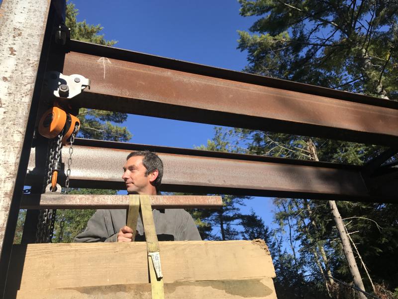Museum board member Jason Lamontagne travels the track toward another day of track-laying Oct. 6 with the crane he engineered. SUSAN JOHNS/Wiscasset Newspaper