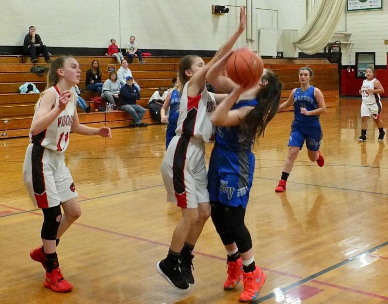 Brianna Orr blocks a shot. To the left is Zoe Waltz while in the background are Mountain Valley’s Taylor Henry and Wiscasset’s Latisha Wright. PHIL DI VECE/Wiscasset Newspaper