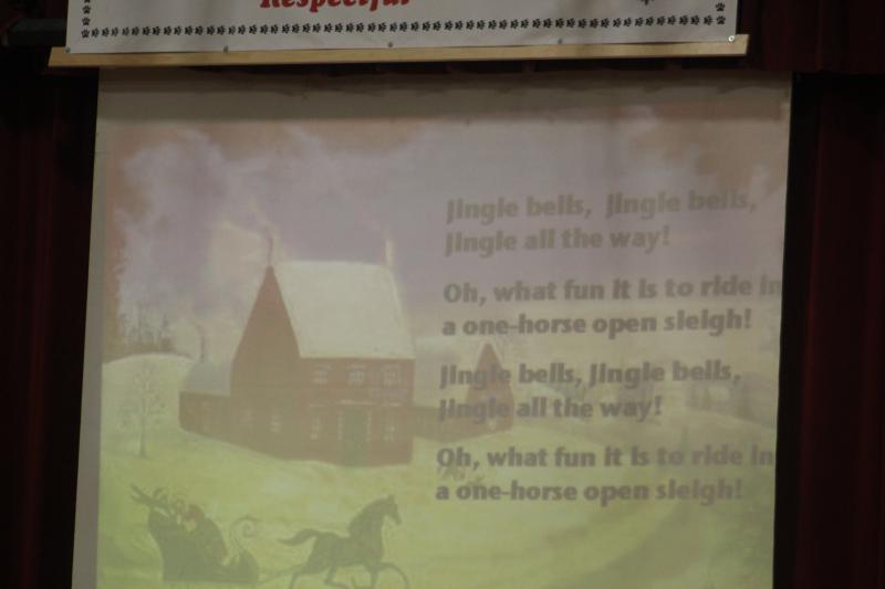 A projector screen projected lyrics for the audience.