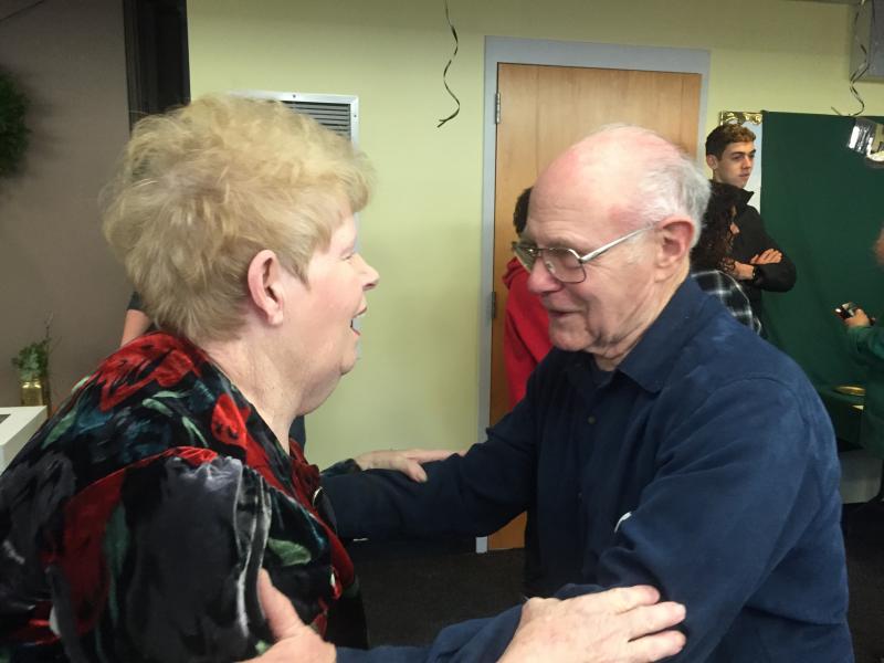 Lynn Murray of Gainsville, Florida and Wiscasset's Tony Gatti catch up at his surprise 80th birthday party at Wiscasset Community Center Dec. 15. SUSAN JOHNS/Wiscasset Newspaper