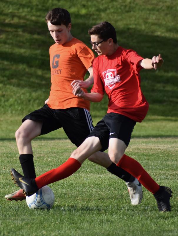 Wiscasset’s Aiden Foley wearing the red jersey competes in the first period. PHIL DI VECE/Wiscasset Newspaper