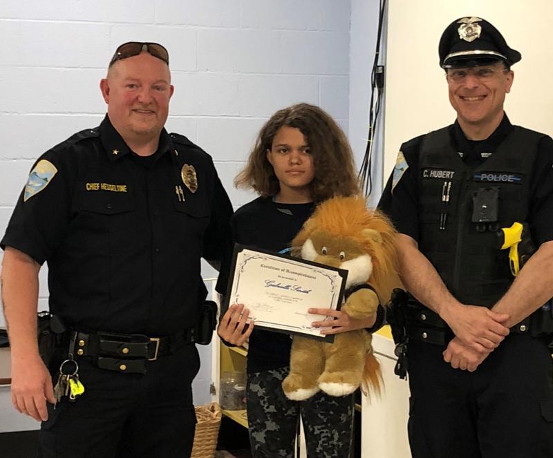 Chief Larry Hesseltine and SRO Cory Hubert congratulate essay winner Gabrielle Smith, who received a $100 gift certificate, the DARE bear and a certificate. Cindy Collamore photo