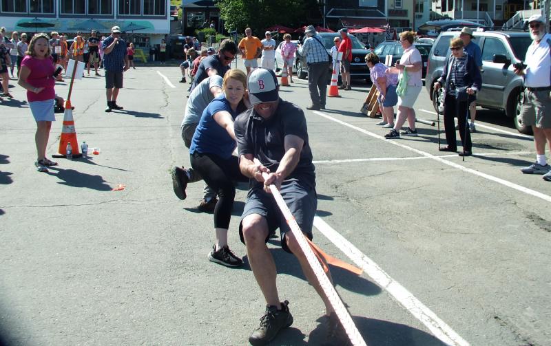 Jennifer Marden, far left, cheers on her husband Eric and daughter Lindsay during the final tugs against Clear Stream. LISA KRISTOFF/Boothbay Register