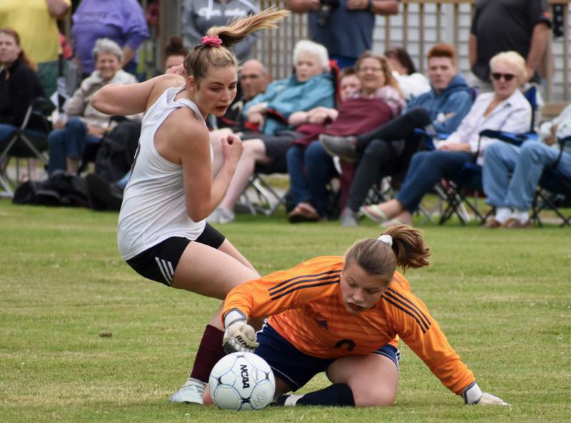 Goalie Lily Souza drops to the turf for a save in Wiscasset’s game against host Richmond. PHIL DI VECE/Wiscasset Newspaper