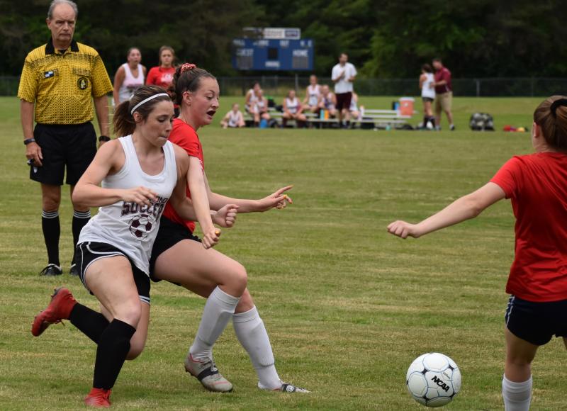 A good deal of action in the Wiscasset-Richmond game took place at midfield. That’s Wiscasset’s Gwen Webber in the center. PHIL DI VECE/Wiscasset Newspaper