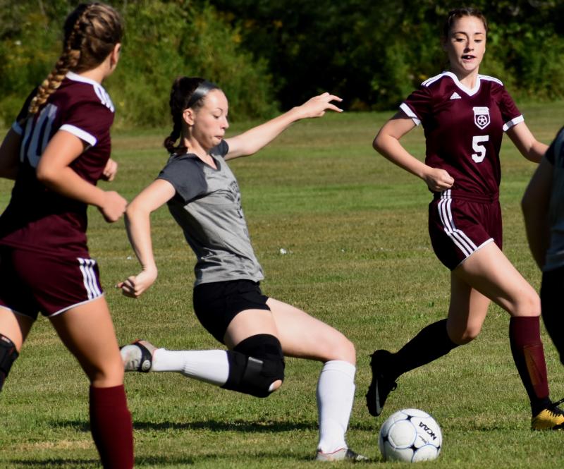 Gwen Webber weaves between two Richmond players. PHIL DI VECE/Wiscasset Newspaper