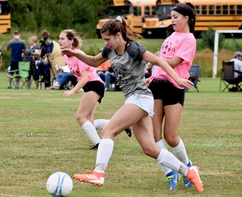 Cara Viele carries the ball past a Madison defender at Saturday’s “Kickoff Classic.” PHIL DI VECE/Wiscasset Newspaper
