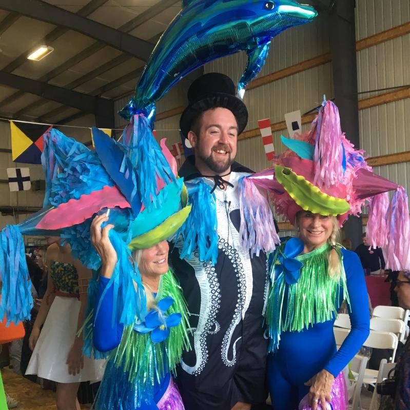Emcee Michael Maxim looks quite happy with a Bielli sister – Andy and Adele – on each arm after last year’s show. File photo