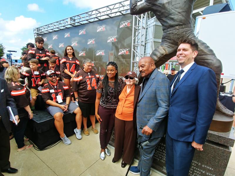 Beverly Graham, Otto’s widow, and Cleveland Brown great Jim Brown (center) and others gather near the statue of Otto Graham. Courtesy of Duey Graham