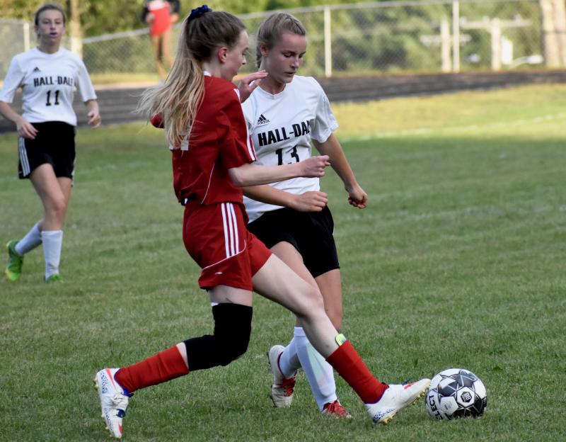 Zoe Walsh defends against Hall-Dale’s Iris Ireland. PHIL DI VECE/Wiscasset Newspaper