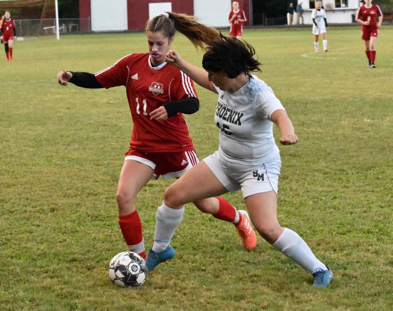 Wiscasset Middle High School rallied but visiting Spruce Mountain was the victor Tuesday. Shown are Cara Viele and Riley Gray of the Phoenix. PHIL DI VECE/Wiscasset Newspaper