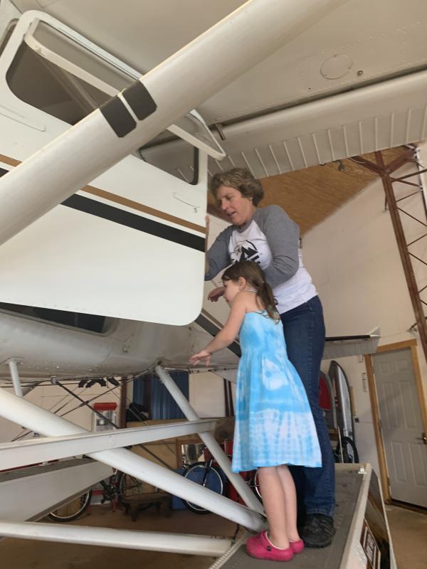 Savannah Robinson, 4, of Alna peers in as pilot Lisa Reece shows her into a Cessna 185 float plane Sept. 2 at Wiscasset Municipal Airport. SUSAN JOHNS/Wiscasset Newspaper
