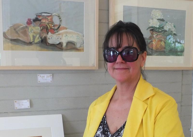 Karen “Kallena” Chutsky in front of two framed paintings she created at age 10. LISA KRISTOFF/Boothbay Register