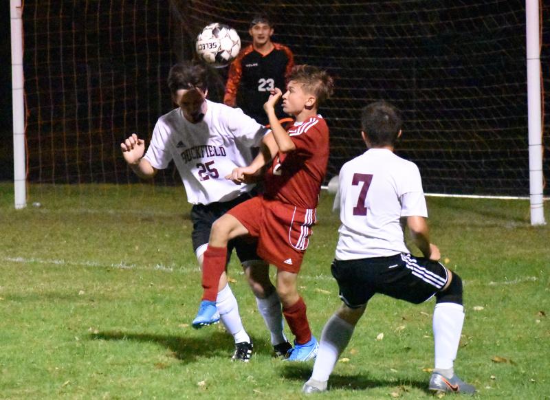 Wolverine Payton Blagdon is hemmed in by Buckfield defenders Taz Keough #25 and Hunter Driscoll. PHIL DI VECE/Wiscasset Newspaper
