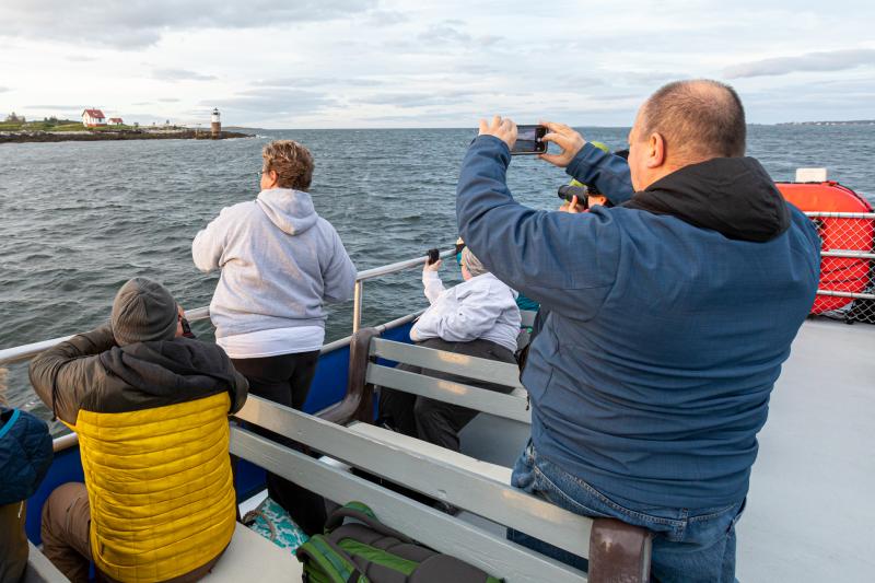 Some of the 30+ attendees take photos of Ram Island. Mike Leonard photo