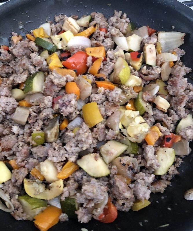 Heat the veggies and sausage together before loading them onto the zucchini. Lisa Orne Hallinan photo