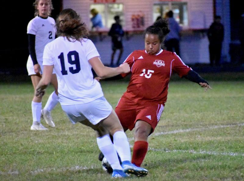 Latisha Wright battles with Dylan Ducette #19 for possession of the ball. PHIL DI VECE/Wiscasset Newspaper