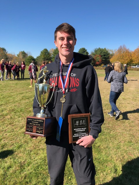 Athlete Will Perkins holds the MVC Championship trophy and the plaque honoring him as runner of the year. Courtesy photo