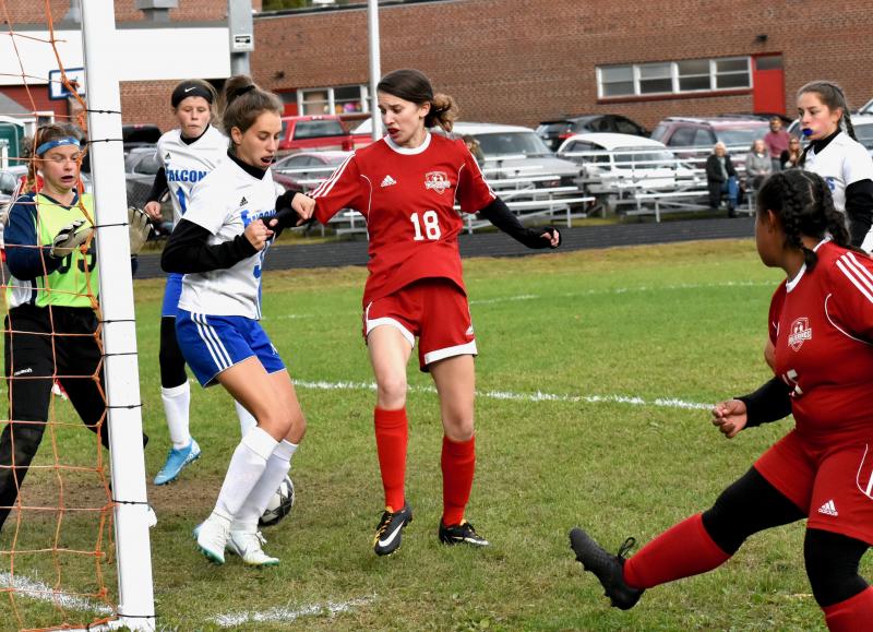 Natalie Potter #18 goes for a loose ball off the foot of Latisha Wright, shown on the right. PHIL DI VECE/Wiscasset Newspaper