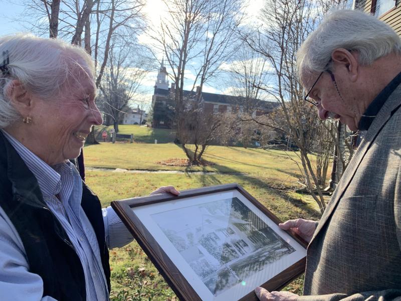 Perry Palmer hands a 20th century photo of William Dykes’ 1700s house to him Nov. 21 in Wiscasset. SUSAN JOHNS/Wiscasset Newspaper