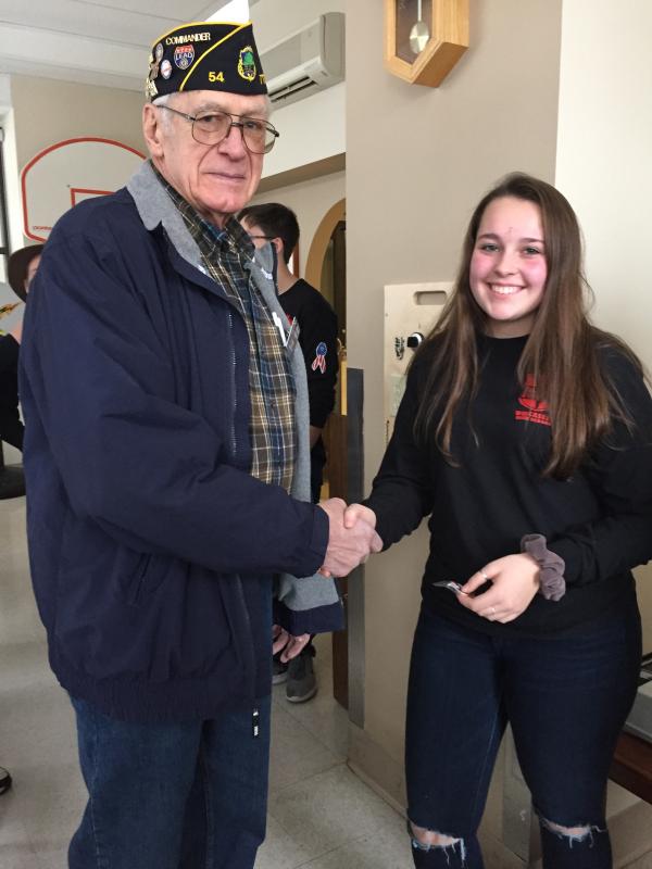 American Legion Regional Commander Bill Cossette Jr. of Wiscasset presents sophomore and student council member Hailey Talert with an American Legion service pin. Courtesy of Deb Pooler
