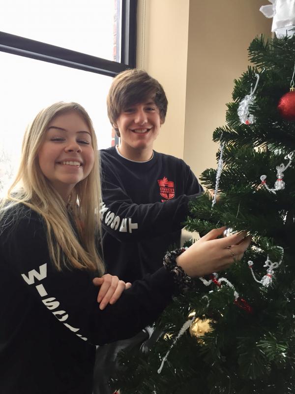Student council members Kaitlyn Main and Billy Pinkham, both seniors, decorate a holiday tree for veterans at Togus. Courtesy of Deb Pooler