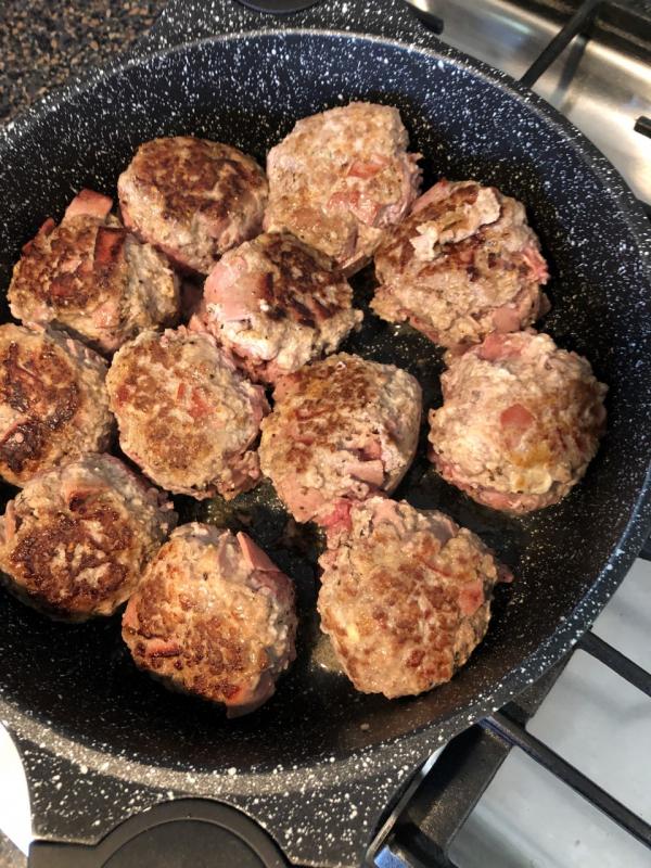 After cooking on one side, add the white wine to the meatballs. Lisa Orne Hallinan photo