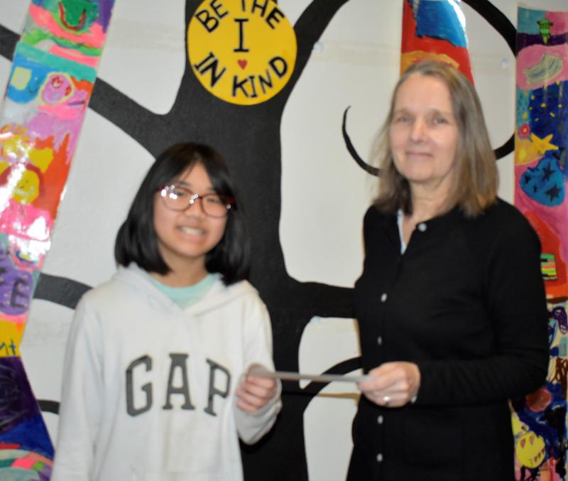 Congratulations to Chau Nguyen! Above, WJD Committee member Rosemary Bourette presents the Boothbay Region Elementary School fifth grader with the first place award. LISA KRISTOFF/Boothbay Register