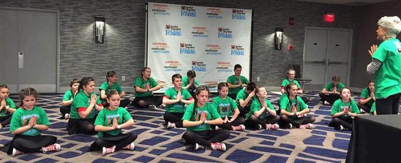 Donna Griffin leading the team in a yoga warmup prior to adjudication. Courtesy of Emily Mirabile
