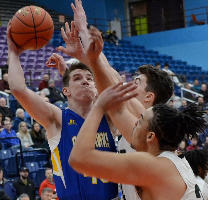 Boothbay senior Hunter shoots against Waynflete’s tall frontline Feb. 20 in the Class C South semifinal. No. 3 Boothbay lost 53-41 against the second-ranked Flyers. KEVIN BURNHAM/Boothbay Register