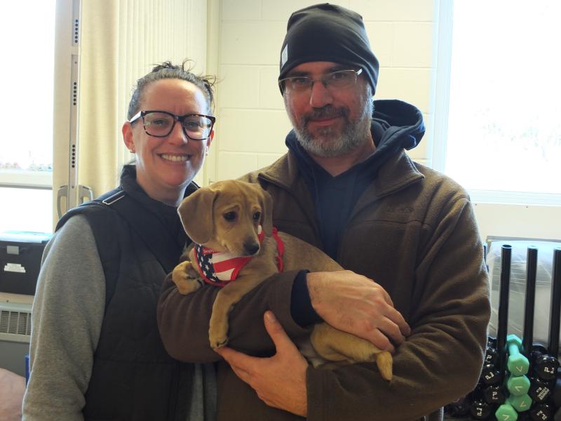 Greg and Toni Hallee of Lisbon Falls found a playmate for their dog by adopting this 3-month-old dachshund-mix during the pet adoption. BILL PEARSON/Boothbay Register